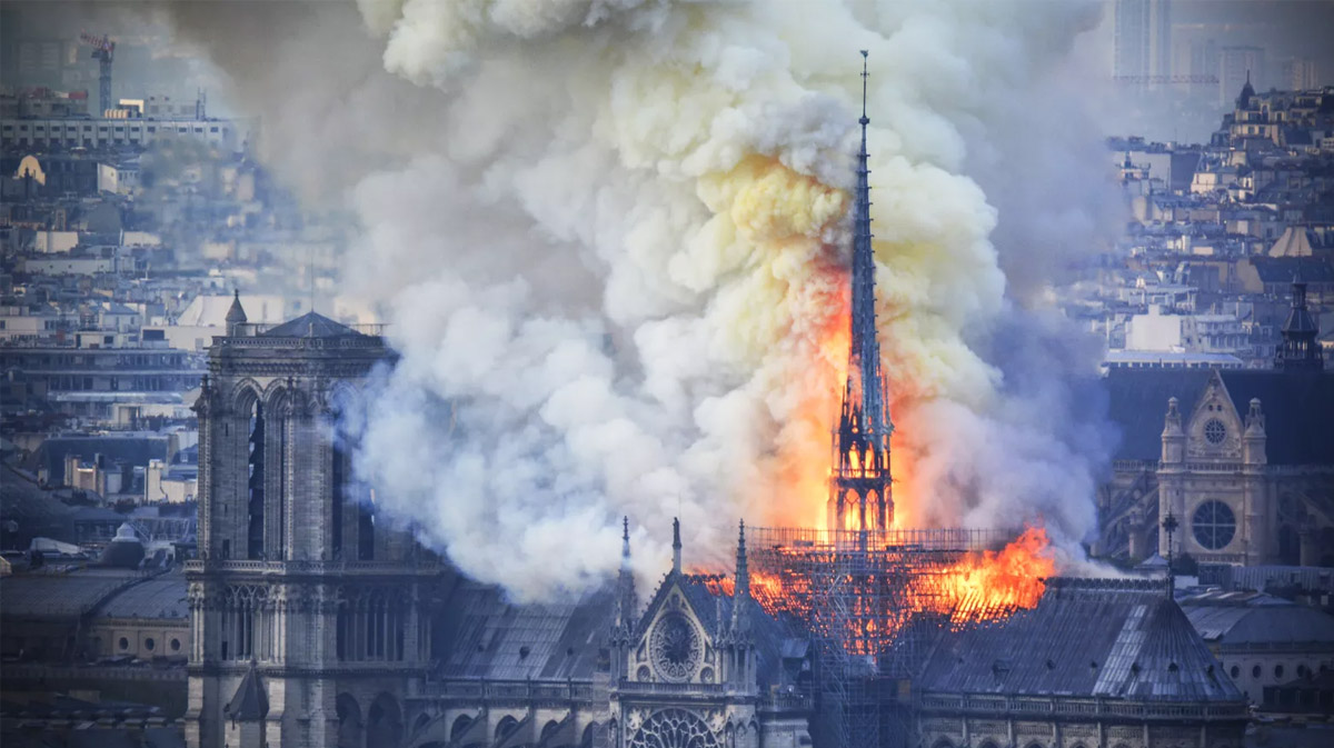 Smoke and flames rise during a fire at the landmark Notre Dame Cathedral in central Paris, France, on April 15, 2019. (Credit: Hubert Hitier/AFP/Getty Images)